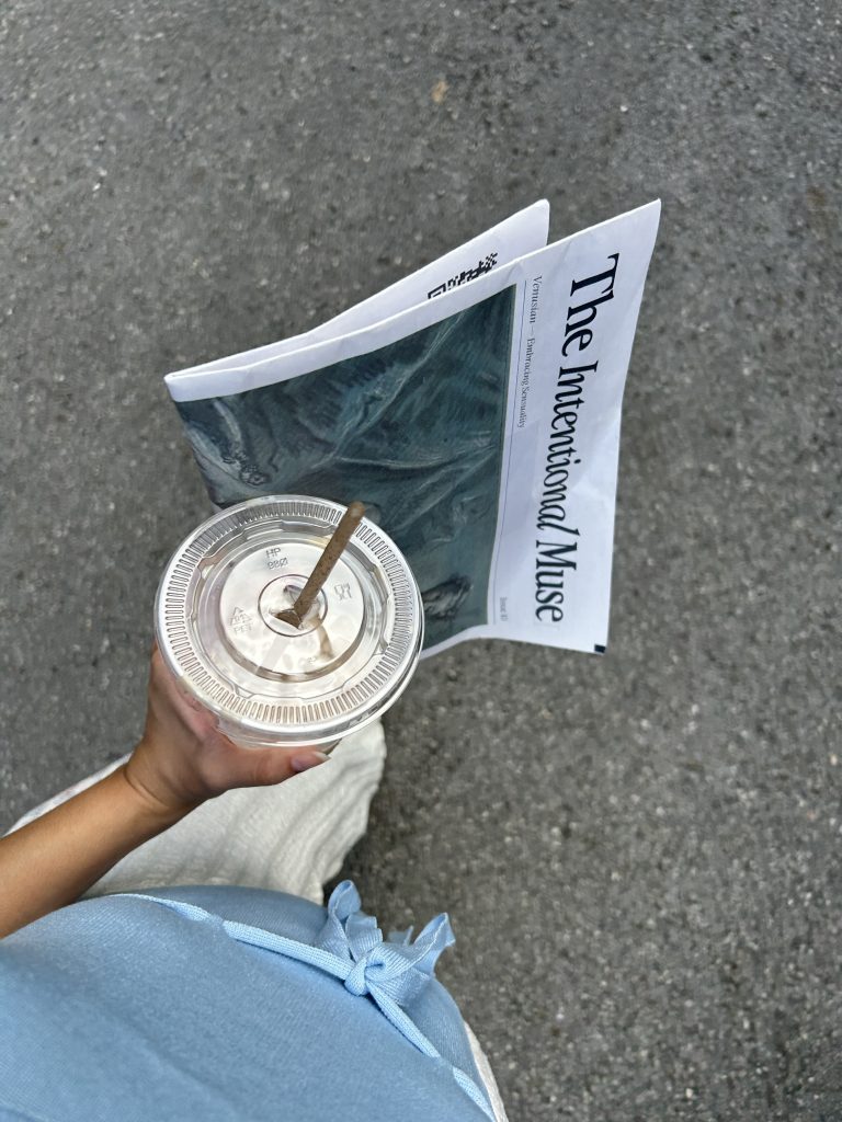 a woman holding a coffee