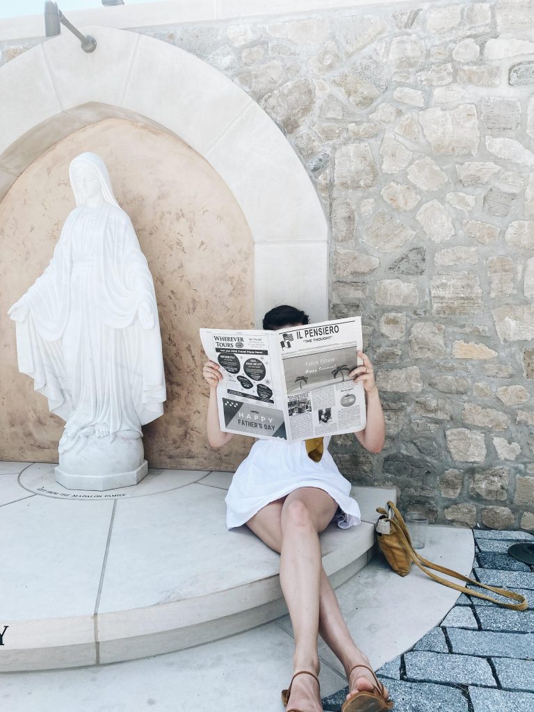 a girl reading a newspaper