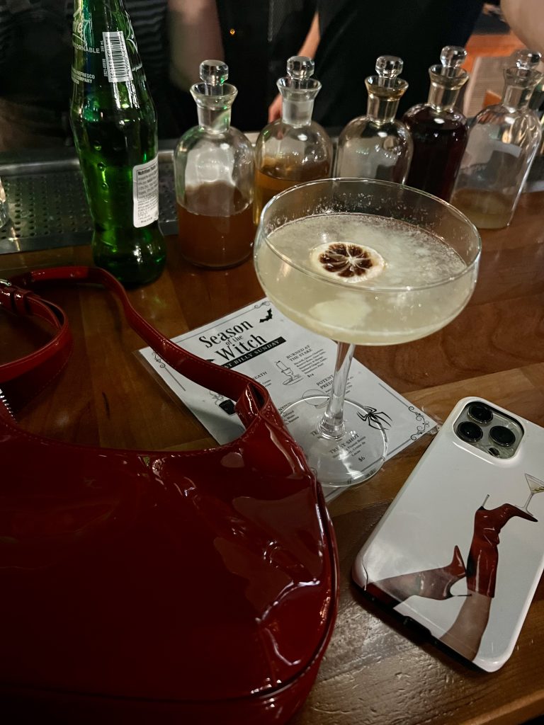 a handbag and drinks on a table